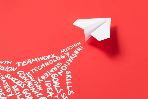 istock Paper Plane on Red Background with Business Related Words 1387155788