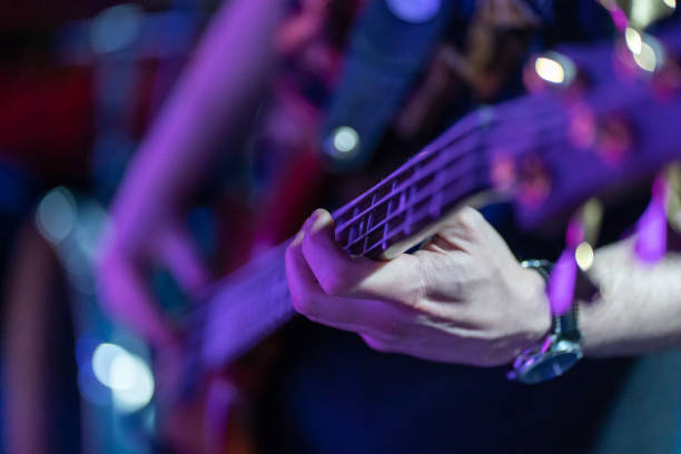 unrecognizable person. Plucking the strings of the electric guitar at a concert stock photo