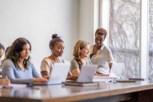 istock Teacher Helping Adult Students 1387157399