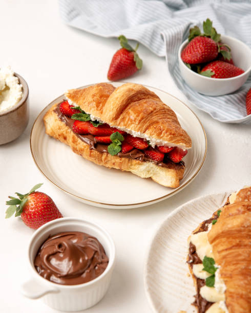 istock Close up croissant with strawberry, chocolate and cream. Breakfast table. 1387158613