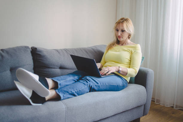 istock A mature woman using her laptop for watching video content 1387159489