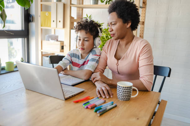 istock Mother helps her son to study at home 1387160276
