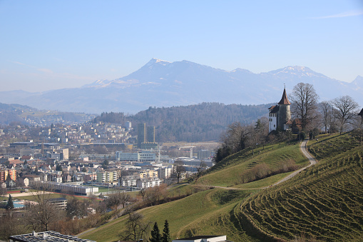 View from the Mount Pilatus cable car towards Mount Rigi. Houses of Kriens and Schauensee Castle.