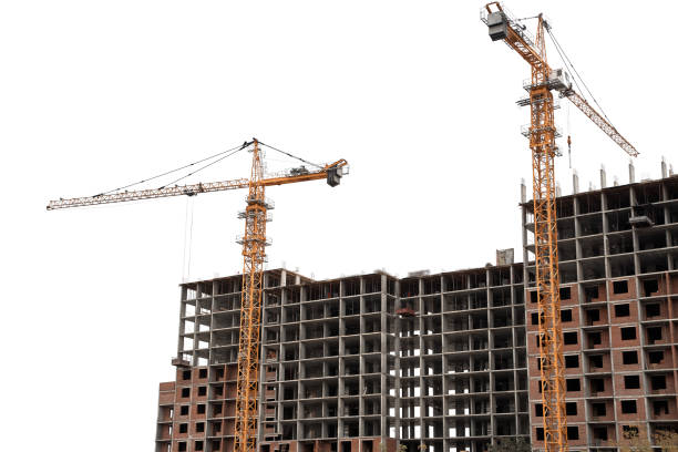 istock Construction yellow cranes and frame of new multi-storey building on a white background 1387162575