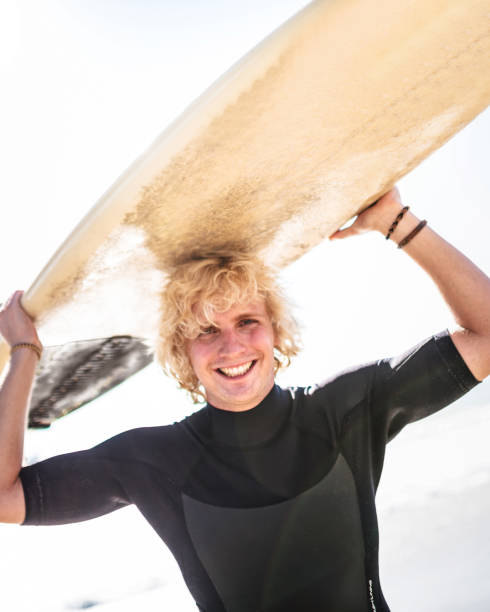 istock happiness surfer with the surfboard 1387163530