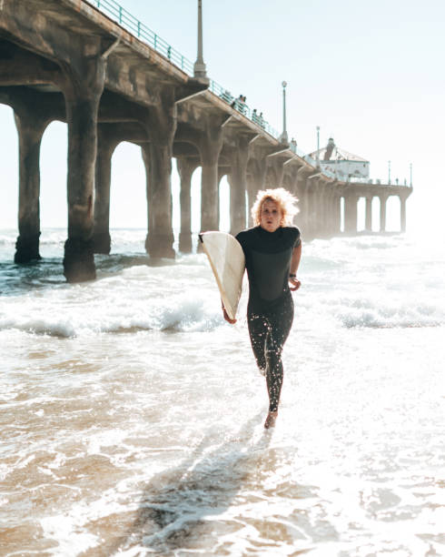 istock happiness surfer with the surfboard 1387163562