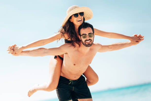 istock piggybacking in the waterfront at the beach 1387164578
