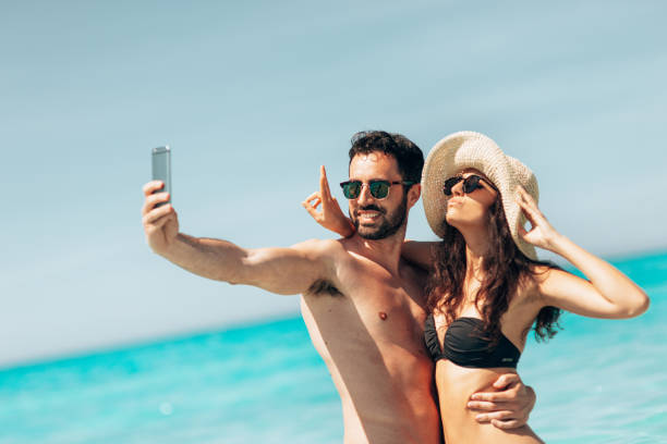 couple take a selfie on the beach in summer