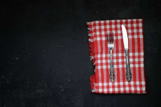 istock Overhead shot of silverware on black table with copy space. 1387169271