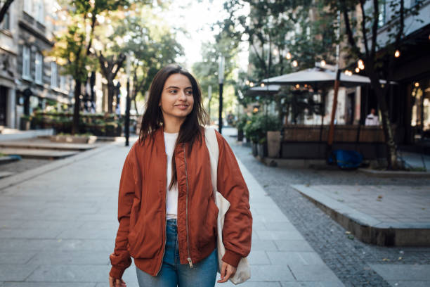 istock Girl walking down the street 1387172221