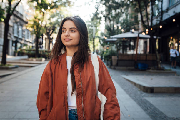 istock Girl walking on sidewalk 1387172222