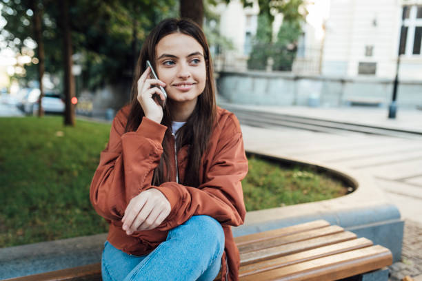 istock Beauty young lady talking on mobile 1387172259