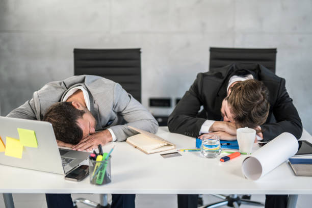 istock Tired businessmen sleeping in the office. 1387175040