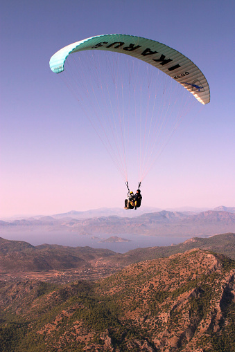 Fethiye, Turkey - October 22: Paraglider fly from Mount Babadag, October 22, 2003 in Fethiye, Turkey. Mount Babadag near Fethiye and a famous paragliding area in Turkey.