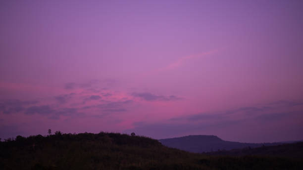 istock Sunset twilight gradient purple pink night sky with mountain 1387188341