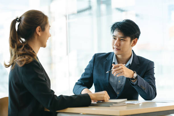 istock Successful young business executives meeting at the office, two people. 1387189727