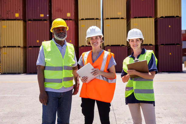 istock African american cargo handler and female engineers looking at the camera holding digital tablet 1387191964