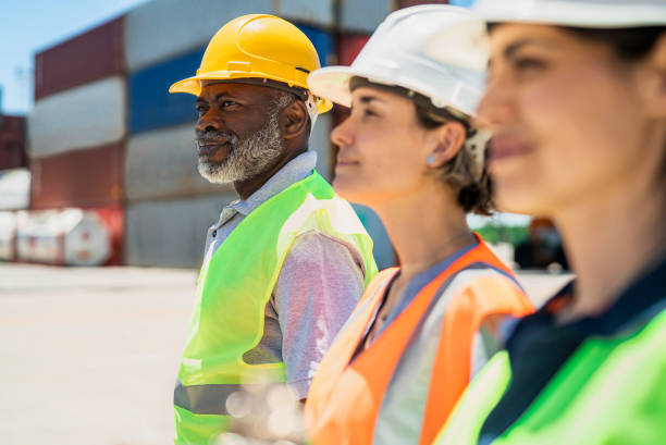 istock Dock coworkers standing next to each others at shipping yard 1387192009