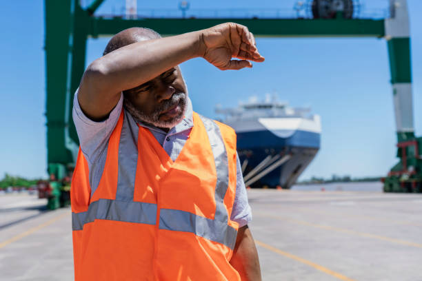 istock African american male dock worker suffering a heat stroke 1387193055