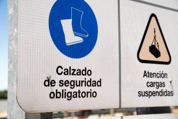 istock Low section of printed security signs written in spanish 1387193187