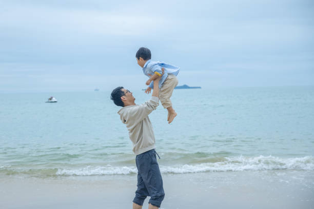 Father with son playing on the beach
