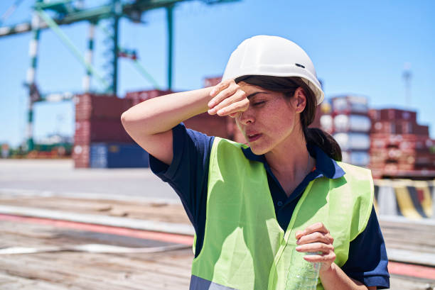 istock Female engineer suffering a heat stroke while holding an empty plastic bottle 1387194104