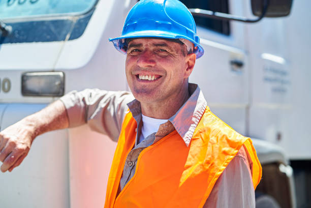 istock Male dock control worker looking at the camera while leaning on truck 1387194139