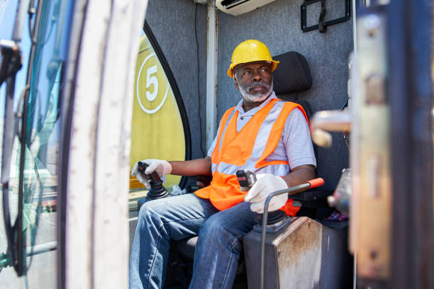 istock African american male cargo handler operating harbor cargo crane during daytime 1387194197