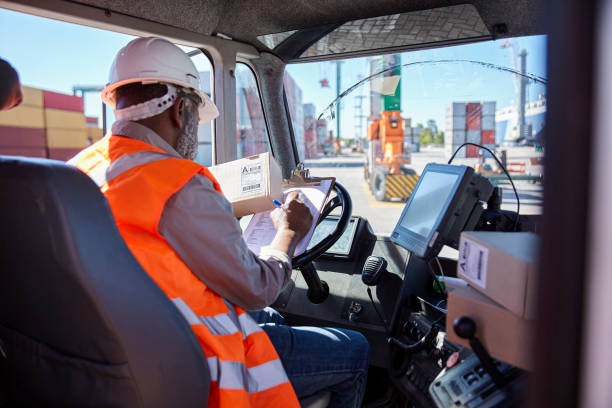 istock African american dock worker distributing packages on shipping containers yard 1387194284