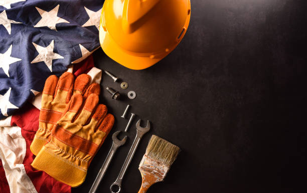 istock Happy Labor day concept. American flag with different construction tools on dark stone background. 1387194453
