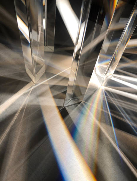 istock A group of clear triangle glass prisms spreading and refracting beam of artificial light. 1387196472