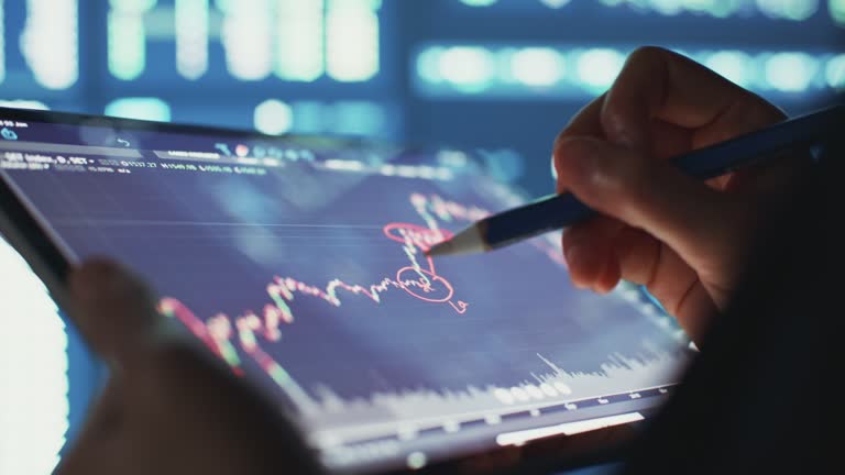 Business people analyzing at graph of stock market data