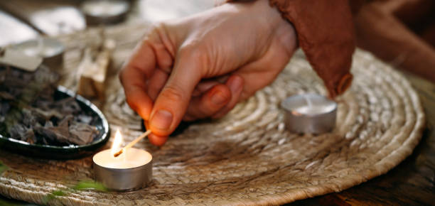 istock Lighting up candles on the table with matches in hand 1387197378