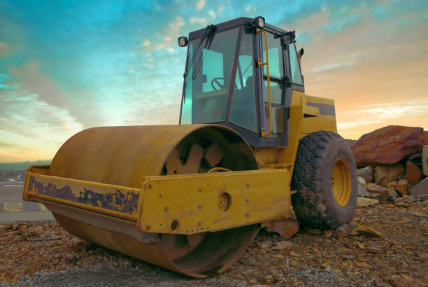 istock construction heavy equipment steamroller yellow machine asphalt compactor sunset sky 1387198993