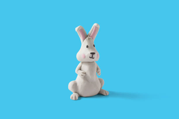 istock Easter white rabbit design handmade with plasticine on a blue background 1387200067