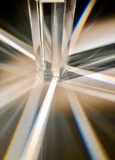 istock A group of clear triangle glass prisms scattering beam of light. 1387200778