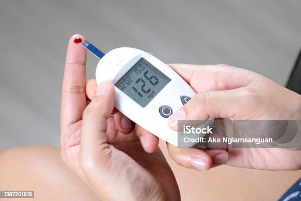 Handchecking Diabetes And High Blood Sugar With Digital Blood Pressure  Monitor And Covid19 Test Results Health And Medical Concepts Stock Photo -  Download Image Now - iStock
