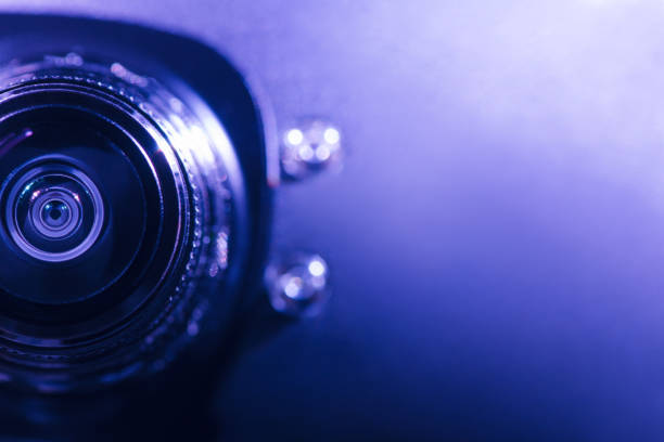 istock .Camera lens with purple and blue backlight. Optics 1387201911