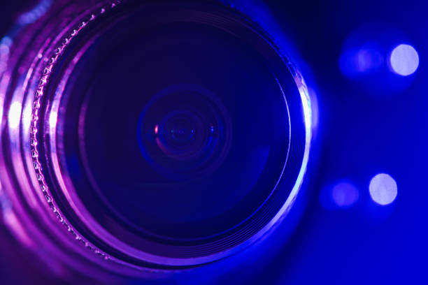 istock Camera lens with purple and blue backlight. Optics. Cyberpunk style 1387201932