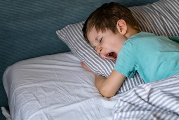 istock Closeup boy sleeping peacefully. Little baby napping in the nursery. 1387203677