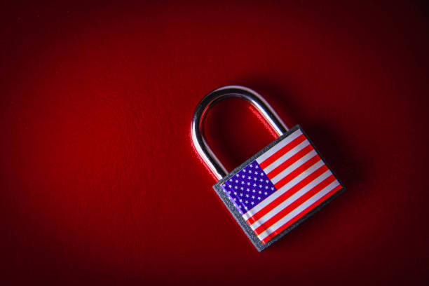 istock US sanctions. Closed padlock with USA flag. Supply ban. 1387211676