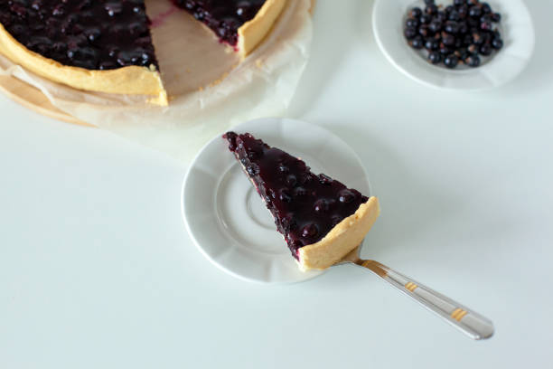 istock Sweet sliced cake with black currant 1387212020