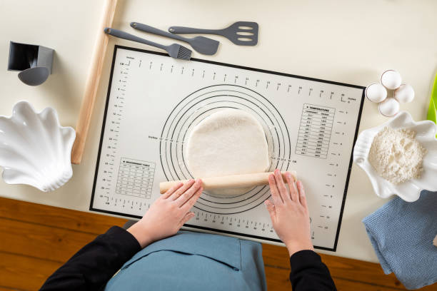 istock Top view of the process of rolling wheat dough on a kitchen mat 1387213726