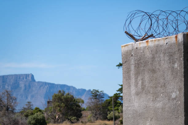 An Iconic shot of Table Mountain taken from Robben Island prison. Barbed wire still covers the high walls.