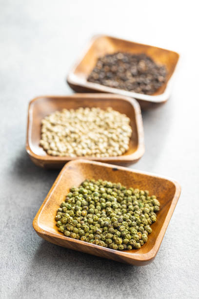 istock Three different types of pepper spice. Green, white and black peppercorn. 1387215079