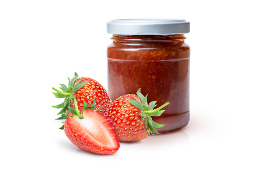 Red strawberry berry jam in glass bottle and fresh strawberries fruit isolated on white background.