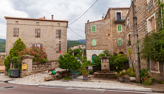 Petreto-Bicchisano, France - August 18, 2018: Corsican old town street view with stone houses and empty square