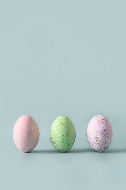 istock Three pastel eggs. Happy Easter greeting card with copy space. Top view. 1387217256