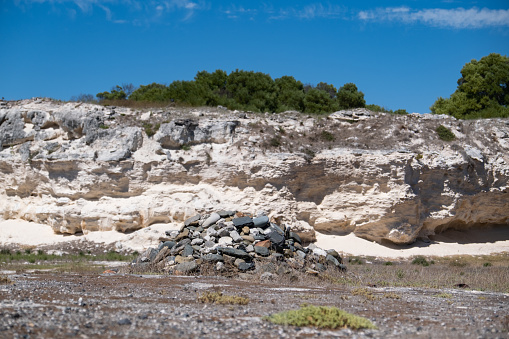 Iconic Lime Quarry on Robben Island with a large pile of stones in the center