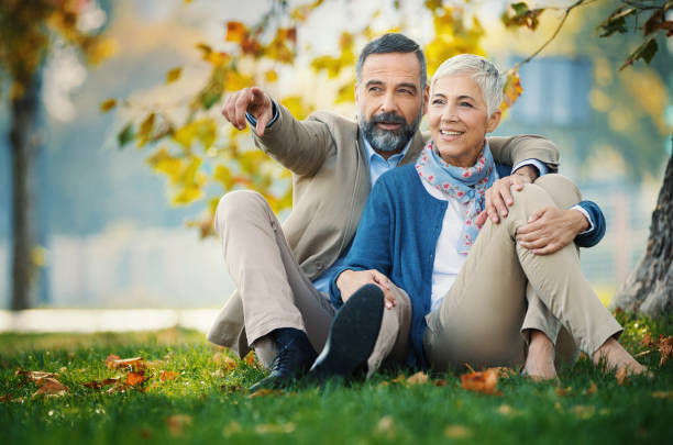 istock Mature couple relaxing in the park. 1387218210